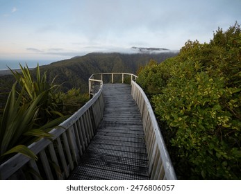 Scenic wooden walkway path leading to viewpoint overlooking Papahaua Ranges lush green bush forest vegetation, Denniston Incline Buller District West Coast South Island New Zealand
