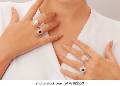 Natural stone ring on elegant lady's finger. Female model shows a gold elegant ring on her finger. Jewelry photography for e-commerce, social media and all platforms.