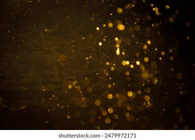 Blurred photo with golden dots visible glittering, shining brightly look and feel luxurious Suitable for use as a wallpaper showing luxury and taste.
