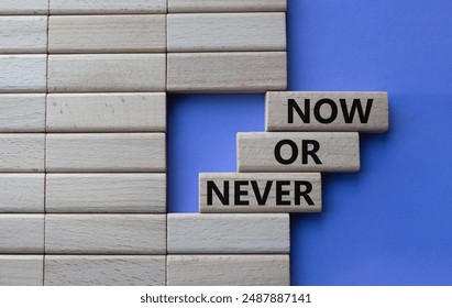 Now or Never symbol. Concept words Now or Never on wooden blocks. Beautiful purple background. Business and Now or Never concept. Copy space