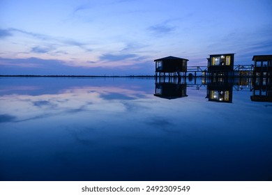Beautiful sunset over the sea with stilt house at dusk of the blue hour in the lagoon e Patok, Patok Lagoon, Fushe Kuqe, Albania
