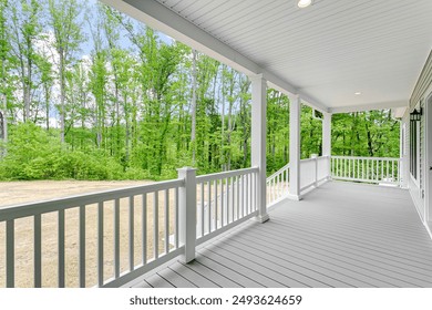 Peaceful Front Porch With White Railings And A Scenic View Of Greenery