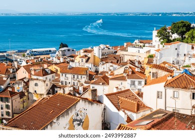 View of Lisbon old town Alfama district with houses clay orange roofs from viewpoint Portas do Sol, Lisbon, Portugal