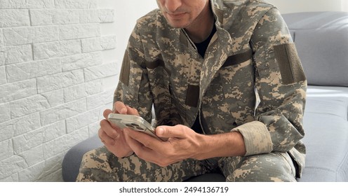 Soldier using a mobile phone against white background