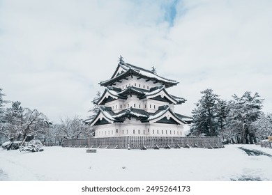 White Hirosaki Castle or Takaoka Castle with snow in winter, hirayama style Japanese castle located in Hirosaki city, Aomori Prefecture, Tohoku, Japan. Landmark for tourist attraction. Japan travel