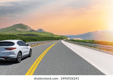 The car is driving along the highway surrounded by picturesque nature.