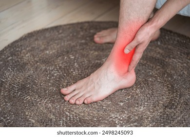 Achilles tendon injury, joint inflammation, foot pain, man suffering from feet ache at home, podiatry concept
