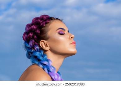 Bright makeup, rose-colored, braids, pigtails hairstyle. Girl colorful kanekalon braided in her hair. Two thick braids of color hair, a youth hairdo, colored hair braids.