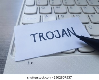 Trojan writting on laptop keyboard background.