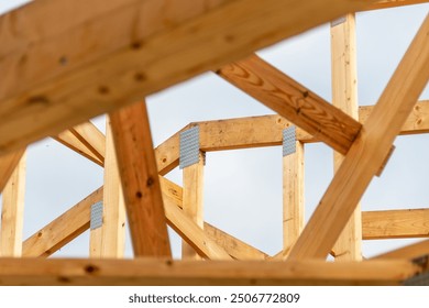 Detailed view of wooden beams and structural reinforcements at a construction site, emphasizing craftsmanship and construction materials used in modern architecture.
