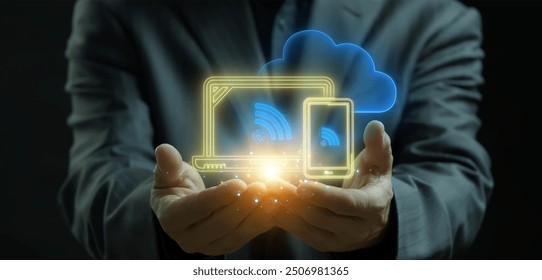 IoT, internet of things, network of interrelated devices that connect and exchange data with other IoT devices and the cloud. Businessman shows glowing neon line of IoT icon on virtual screen.