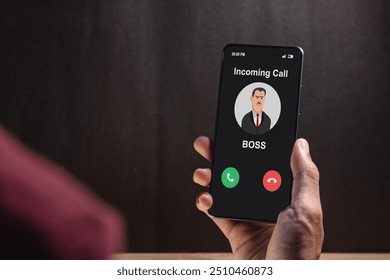 Hand holding a smartphone with incoming call from Boss at night after business hours. Right to disconnect concept.