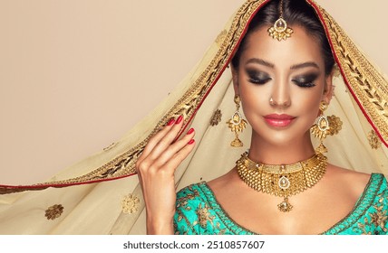 Portrait of beautiful   indian woman . Young India model  girl with Traditional Indian costume  saree  or lehenga choli and  golden jawelery