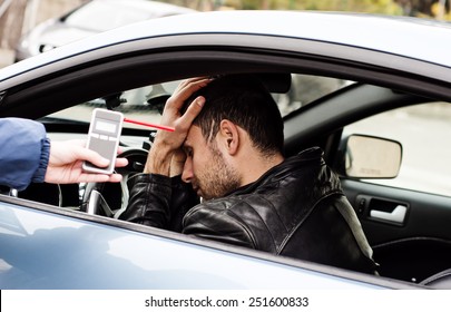 Trinken und Fahren stürzte der Fahrer ab, weil er mit einem Alkoholtester auf Alkoholgehalt getestet wurde. er ist am Boden zerstört