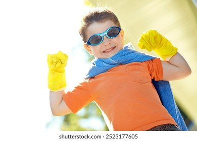 Boy, freedom and superhero outdoor in home with fantasy game, play or pretend character with portrait. Kid, space person or action fist with imagination for child development, adventure and halloween