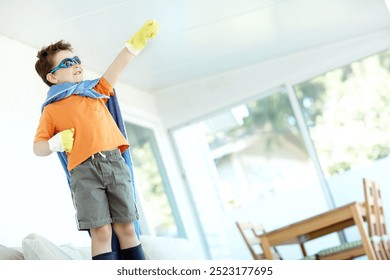 Kid, boy or superhero costume in home with fantasy game, playing or pretend character with smile. Person, power and action fist with imagination for child development, adventure or halloween in house