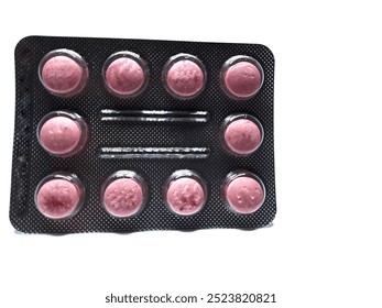 One sheet of red and pink medicinal tablets contains ten pieces isolated on a white background