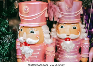 Nutcracker doll. Christmas wallpaper with pink nutcracker.Christmas toys and decorations.Winter festive beautiful background in pink and gold tones