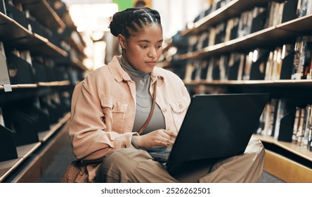 African, woman and student with laptop in library for research information, university news and study schedule. Girl, digital and reading online with education ebook, exam results and project report