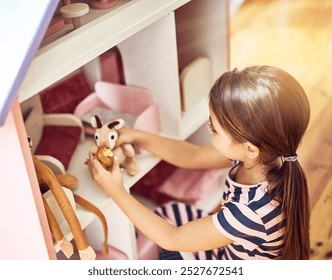Kid, dollhouse and toys in home for game, fantasy play and fun activity with teddy bears. Girl child, creativity and imagination in bedroom with dolls, story development and growth with inspiration