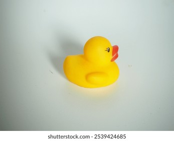 closeup of a yellow rubber duck toy on a white isolated background
