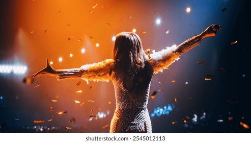 Female Singer Performing in a Striking Silver Costume. Spectacular Concert with a Talented Pop Star. Epic Cinematic Slow Motion Footage with Vibrant Confetti Falling on Artists on Stage