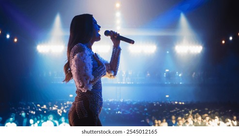 Talent Show Performance: Portrait of a Young Female Pop Singer on a Stage with Colorful Neon Lighting. Musician Singing a Powerful Solo, Poring Her Heartfelt Emotions into Beautiful Music