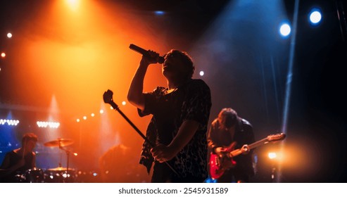 Portrait of a Lead Singer Performing at a Rock Concert Live on Stage with Confetti. Talented Musician Bringing His Unique Attitude, Playing Energetic Rock Hits. Young Band Playing For the Crowd