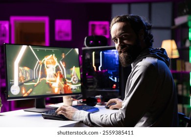 Portrait vun engem Mann, deen e kompetitivt Online-FPS-Videospill genéisst a mat senge Frënn géint fléiend Roboter kämpft. E laachende Gamer schwätzt mat senge Mataarbechter am Internet, während hien e First-Person-Shooter spillt a géint de Boss kämpft.