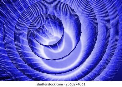 Spiral abstrak dengan nuansa biru, ungu muda, ungu, dan tekstur kawat yang berkilau dengan latar belakang hitam, melambangkan energi, gerak, serta konsep desain industrial dan futuristik. Ruang fotokopi