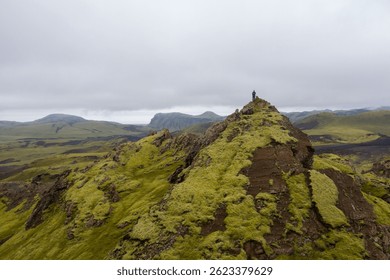 An aerial view of a man on the mountaintop of the Iceland Moss Landscape in Katla Geopark