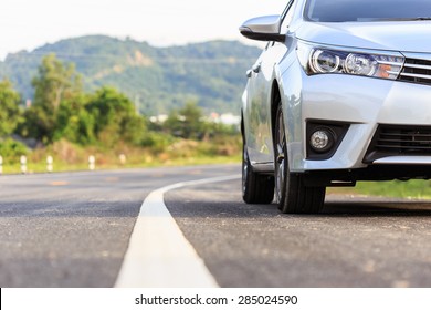 Close up front of new silver car parking on the asphalt road