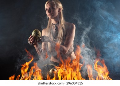 beautiful woman with a nest egg dragons in the fire