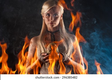 beautiful woman with a dragon egg in hands