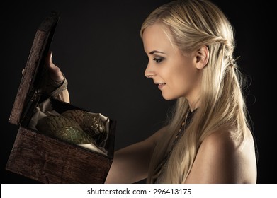 blond woman holding a box with eggs dragons