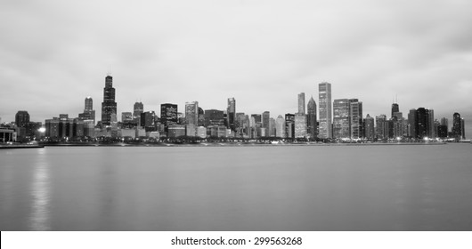 High contrast sunrise lights the long downtown Chicago skyline traditional black and white