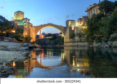 Historic bridge over the Neretva river in Mostar, Bosnia Herzegovina at twilight.