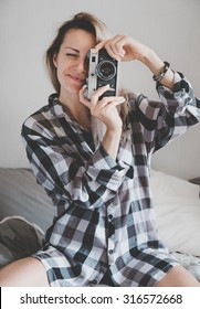 Soft photo of woman in checkered shirt making a picture
