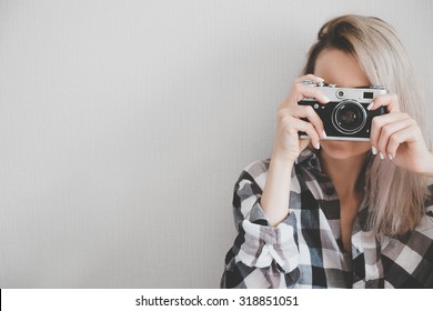 Soft photo of woman in checkered shirt making a picture