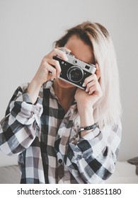 Soft photo of woman in checkered shirt making a picture