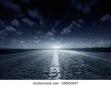Night road against the background of cumulus clouds