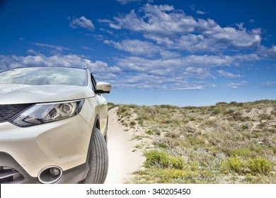 car in the beach dunes