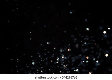 Black bokeh texture on black background