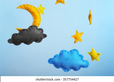 Fleece clouds with moon and stars on blue background