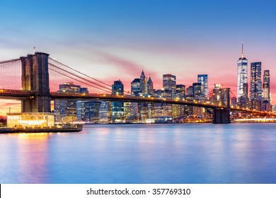 Brooklyn Bridge and the Lower Manhattan skyline under a purple sunset