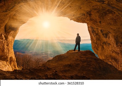 Beautiful amazing sunset. Mountains in north country Russia Caucasus. Unique landscape mainsail. Silhouette of a man. Old cave. Active sport and hobby. Spelunking background. Quest