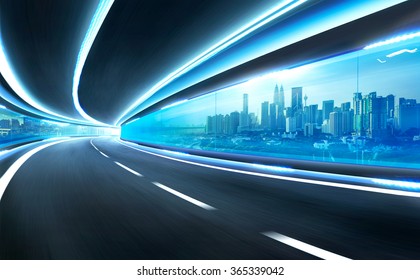 Carretera de movimiento de velocidad borrosa abstracta en túnel de vidrio sobre la ciudad