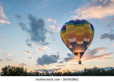 hot air balloon is flying at sunrise