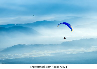 Paraglider flying over the clouds. No limits, paragliding above the clouds.