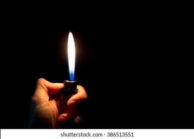 abstract Motion Hand with lighter igniting sparks on dark background
